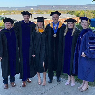 Kenney at the 2022 Penn State graduation with graduate students and colleagues.