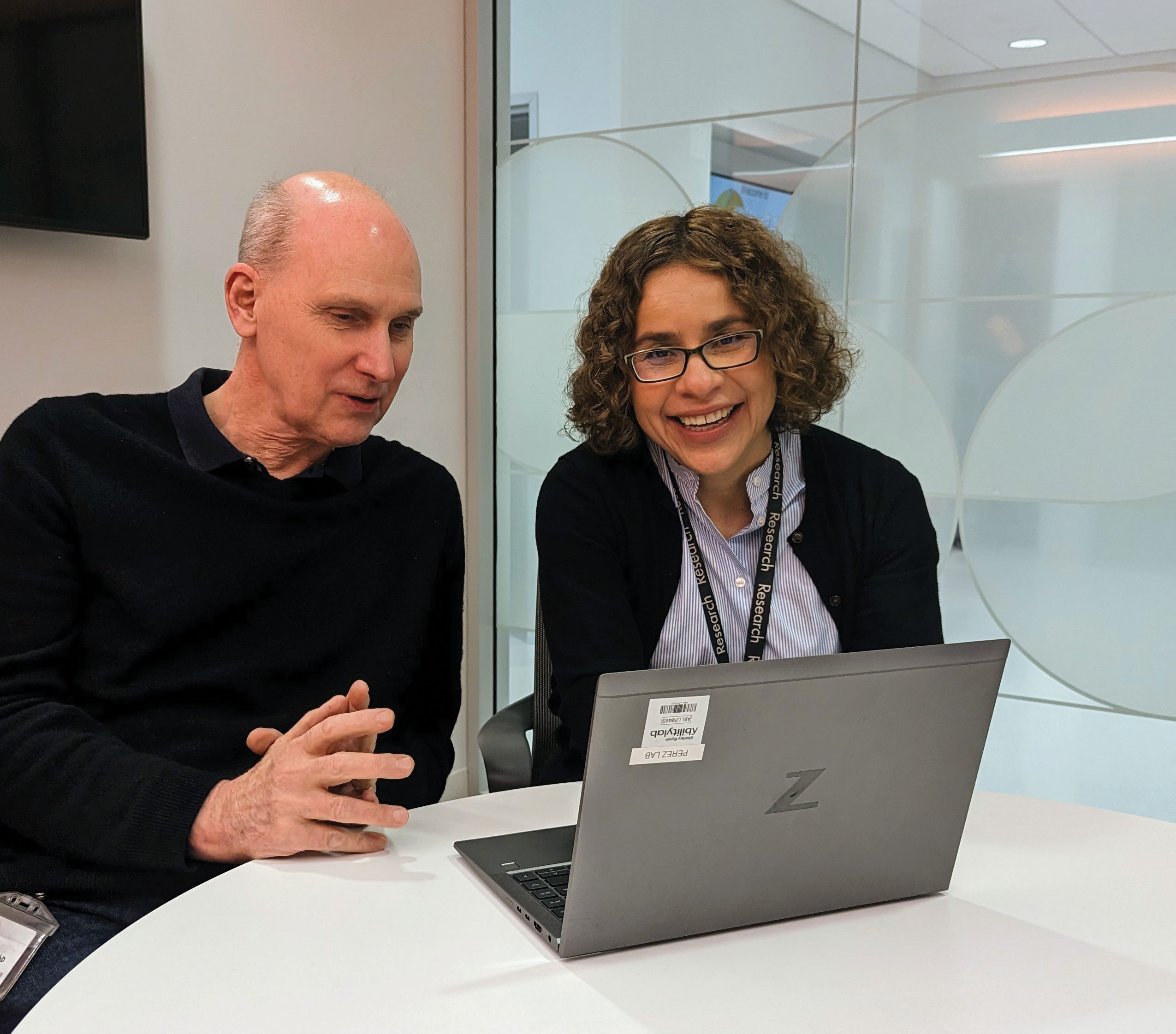 Feature-art_Dr-Perez_6 A man and women have a discussion while looking at a laptop